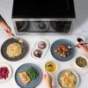 imageFarberware Countertop Microwave 700 Watts 07 Cu Ft  Microwave Oven With LED Lighting and Child Lock  Perfect for Apartments and Dorms  Easy Clean Grey Interior Retro BlackStainless Steel