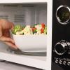 imageNostalgia Retro Compact Countertop Microwave Oven  07 Cu Ft  700Watts with LED Digital Display  Child Lock  Easy Clean Interior  OrangeBlack