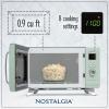 imageNostalgia Retro Compact Countertop Microwave Oven  07 Cu Ft  700Watts with LED Digital Display  Child Lock  Easy Clean Interior  OrangeSeafoam Green