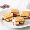 imageNostalgia Indoor Electric Stainless Steel SMores Maker with 4 Lazy Susan Compartment Trays for Graham Crackers Chocolate Marshmallows and 4 Roasting Forks BrownDeluxe Smores Maker